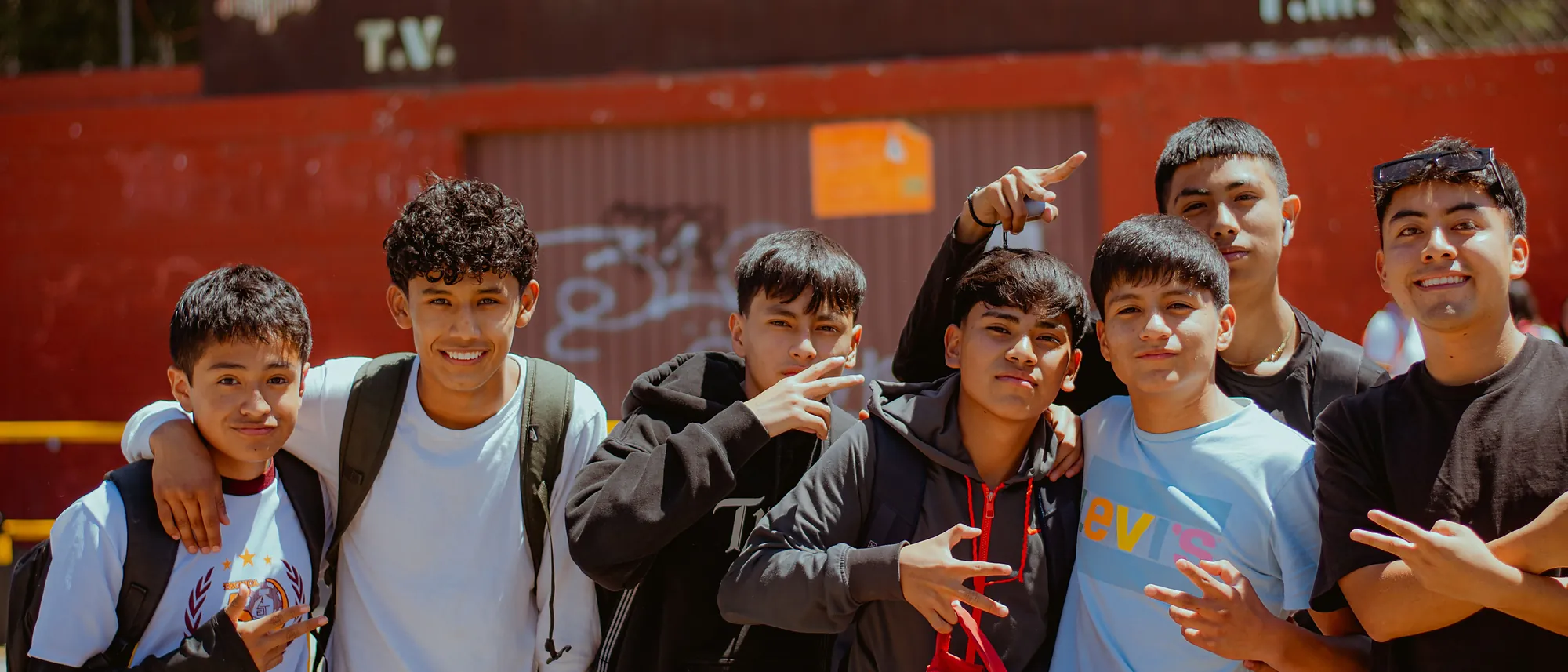 A group of secondary students outside their school