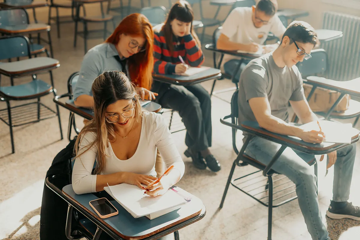 Students taking a written test in a classroom
